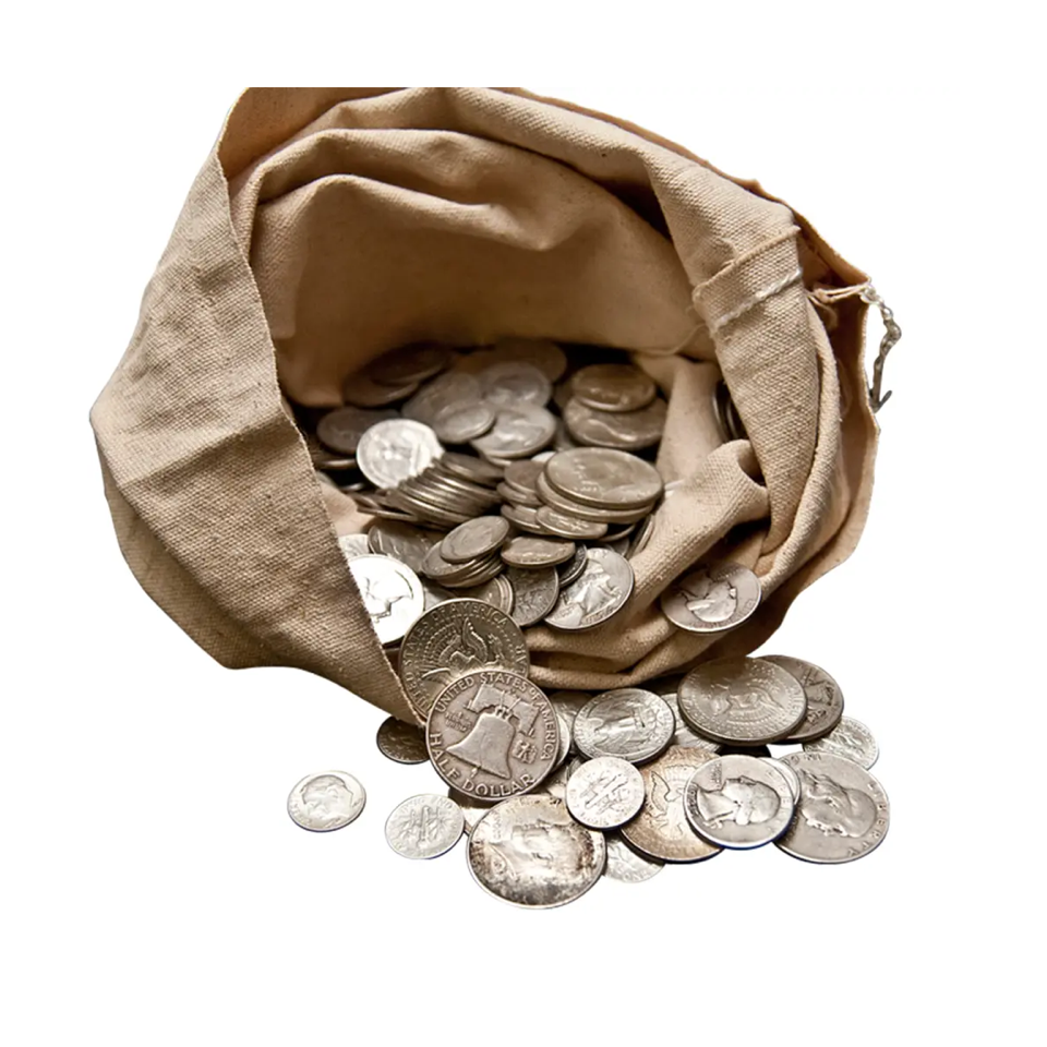Silver coins spilling from a canvas bag on a white surface